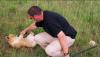 (c) Copyright - Raphael Kessler 2011 - Zimbabwe - Bernie the lion cub at four months and me