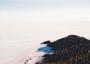 (c) Copyright - Raphael Kessler 2011 - Bolivia - Salar de Uyuni - Guy cycling across the Salar with a dog