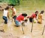 (c) Copyright Raphael Kessler 2011 - Colombia - Volcan de Lodo - Being bathed to get the mud off